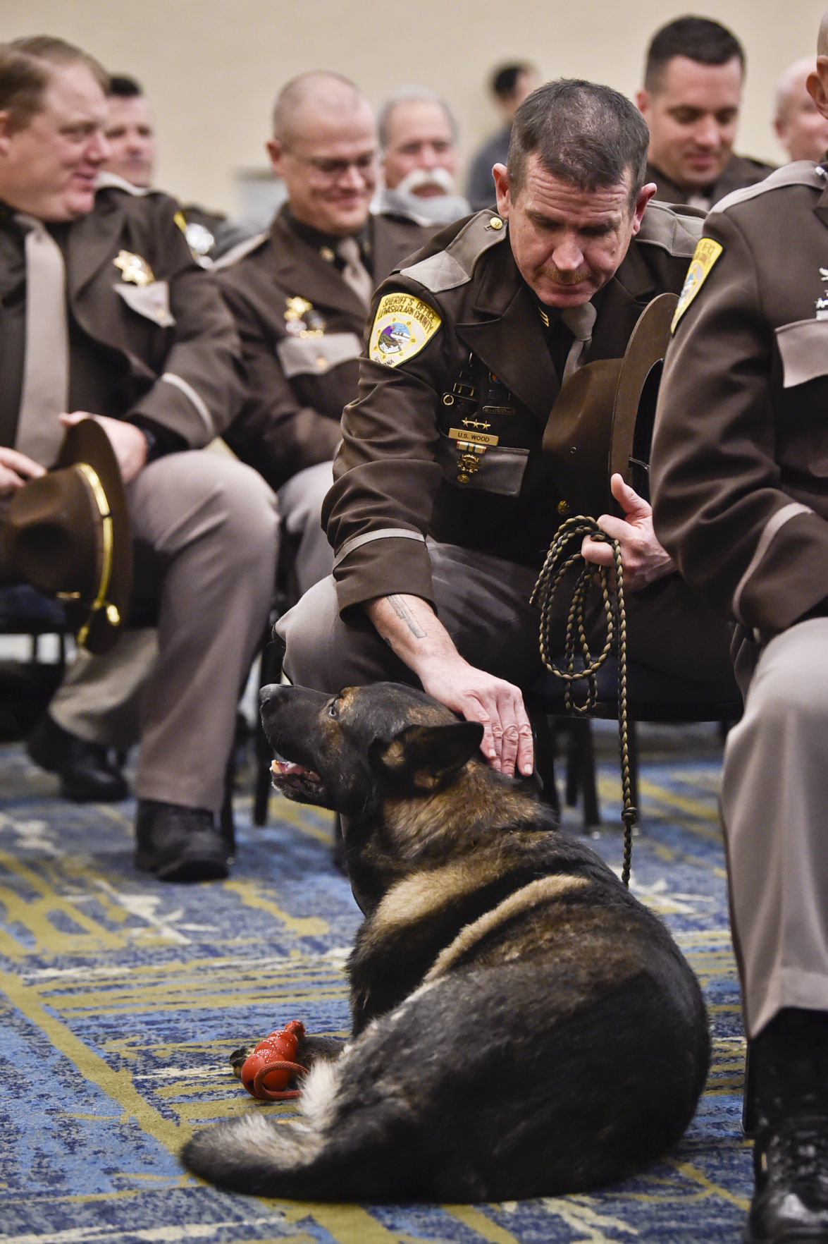 Uriah Wood pets his K9 companion, Villi,